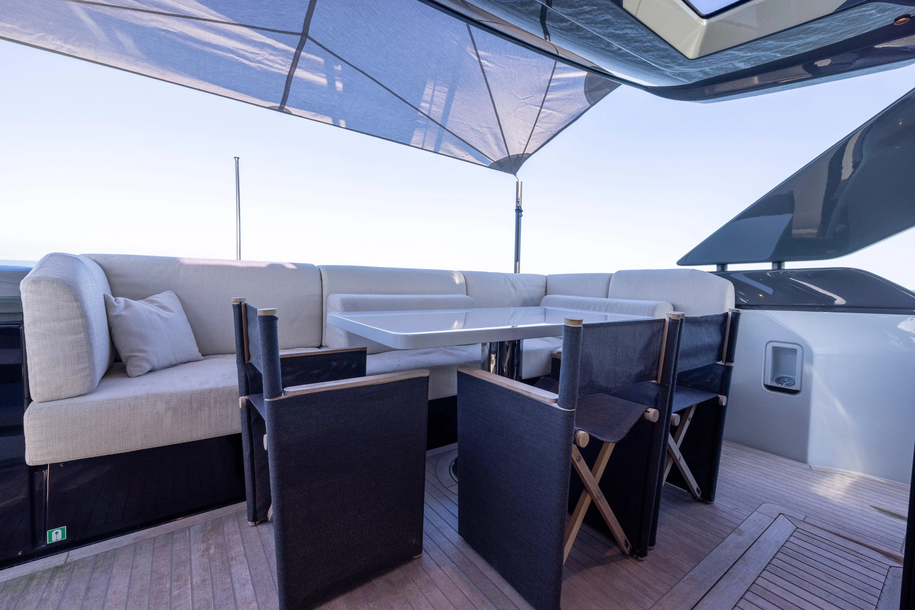 The Calm Down Yacht Photos Pics Luxurious outdoor seating on 2024 Bluegame BGX63 yacht with modern table and chairs.