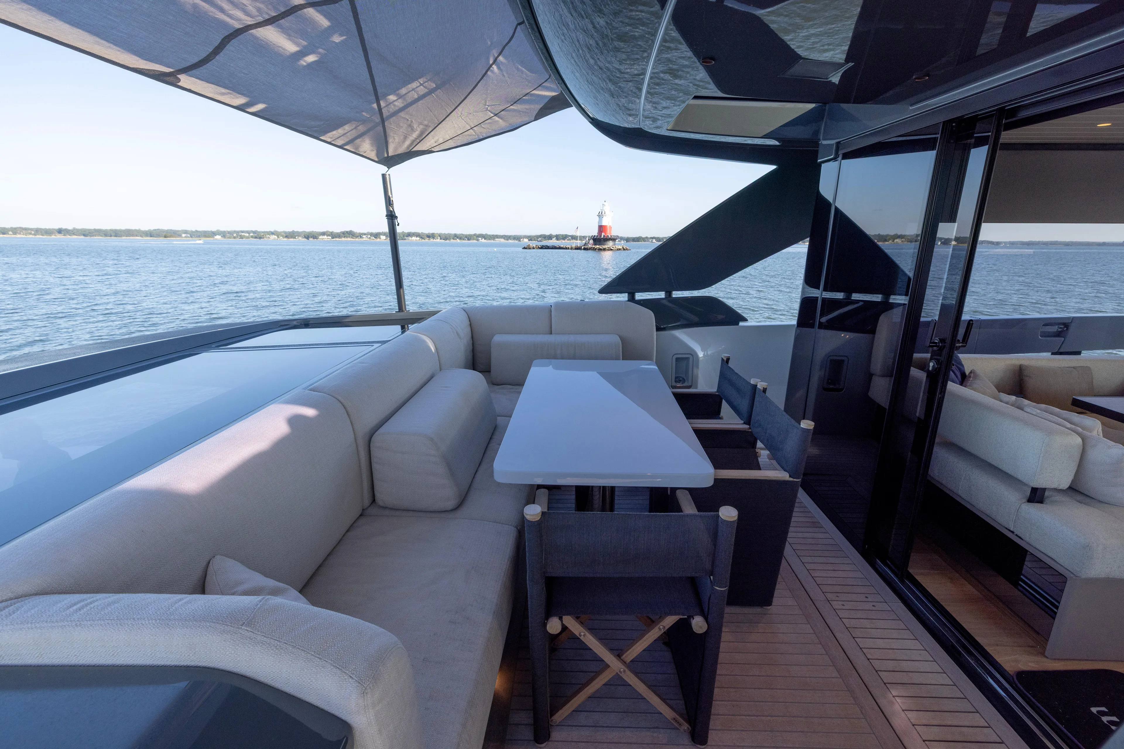 The Calm Down Yacht Photos Pics Luxurious 2024 Bluegame BGX63 yacht deck with seating, table, and ocean view.