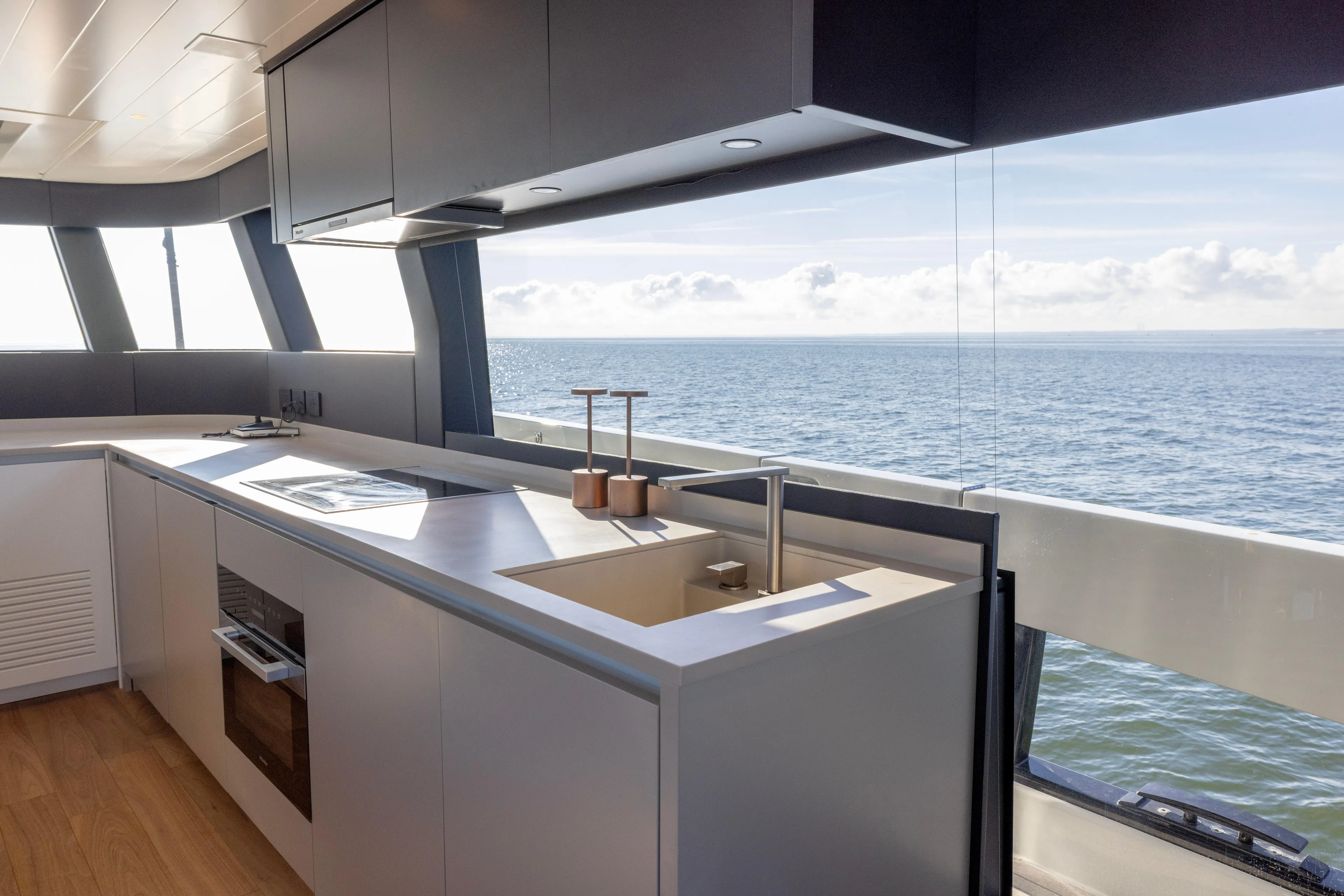 The Calm Down Yacht Photos Pics Modern kitchen interior on 2024 Bluegame BGX63 yacht with ocean view.