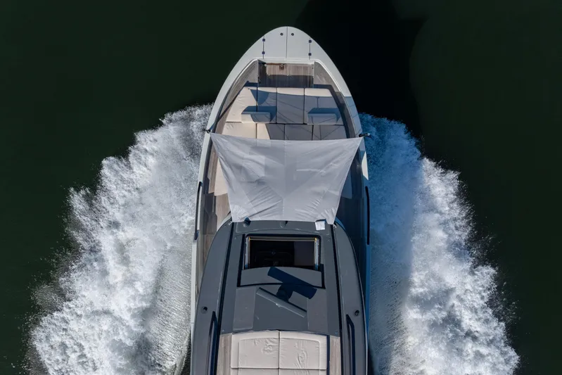 The Calm Down Yacht Photos Pics 2024 Bluegame BGX63 yacht cruising on water, aerial view.