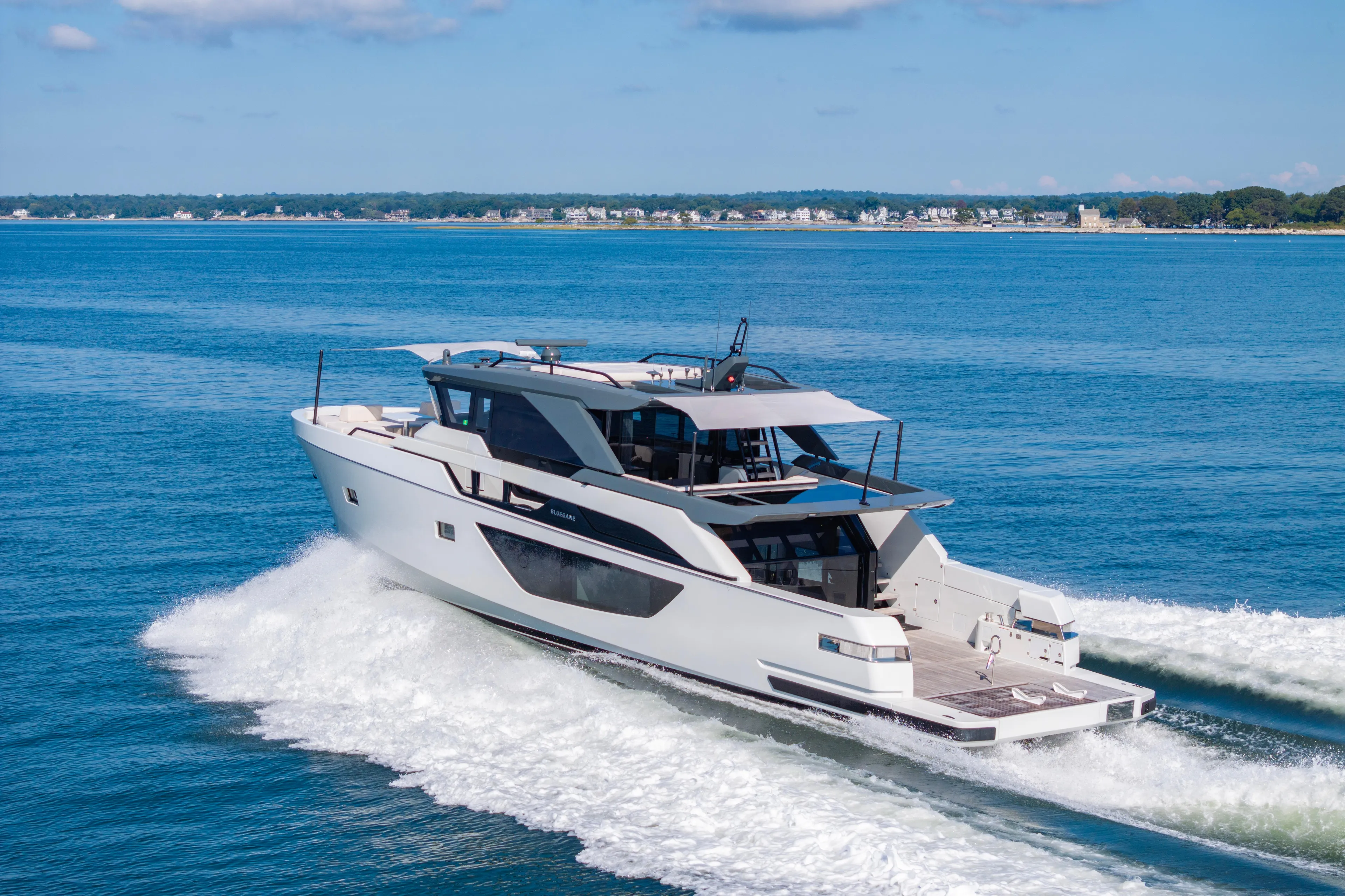 The Calm Down Yacht Photos Pics 2024 Bluegame BGX63 yacht cruising on open water, showcasing sleek design and luxury.