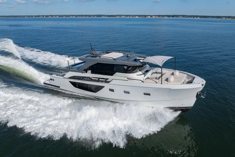 The Calm Down Yacht Photos Pics 2024 Bluegame BGX63 yacht cruising on open water, showcasing sleek design and luxury features.