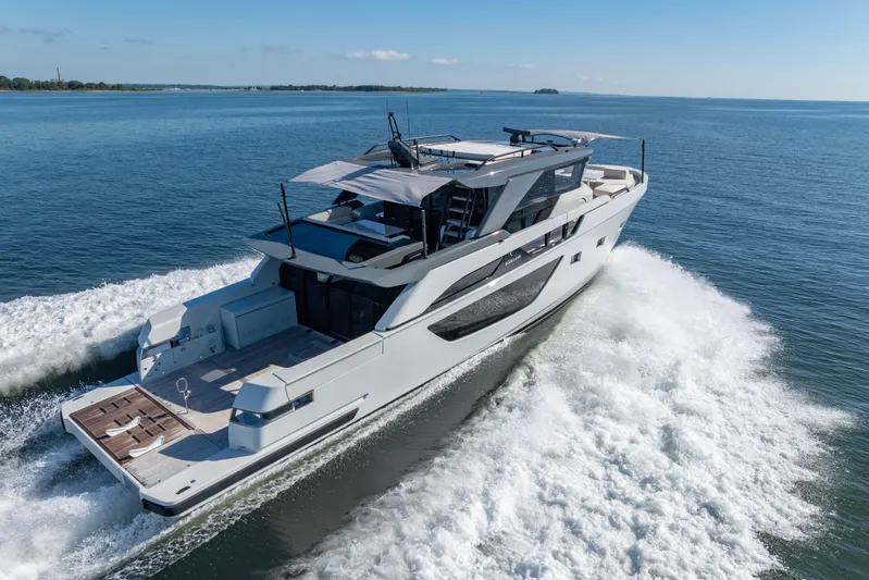 The Calm Down Yacht Photos Pics 2024 Bluegame BGX63 yacht cruising on open water, showcasing sleek design and luxury features.