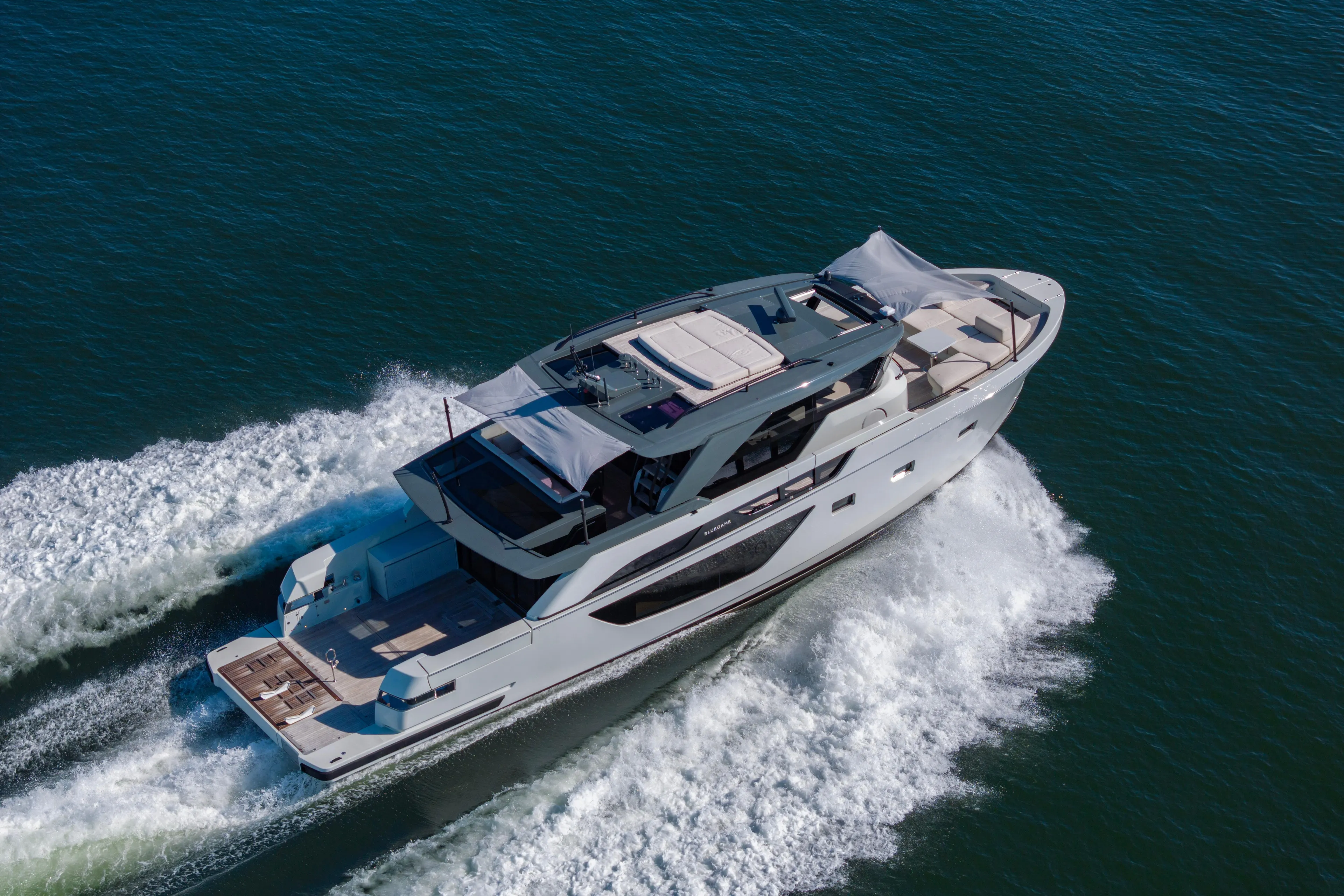 The Calm Down Yacht Photos Pics 2024 Bluegame BGX63 yacht cruising on open water, showcasing sleek design and luxury.
