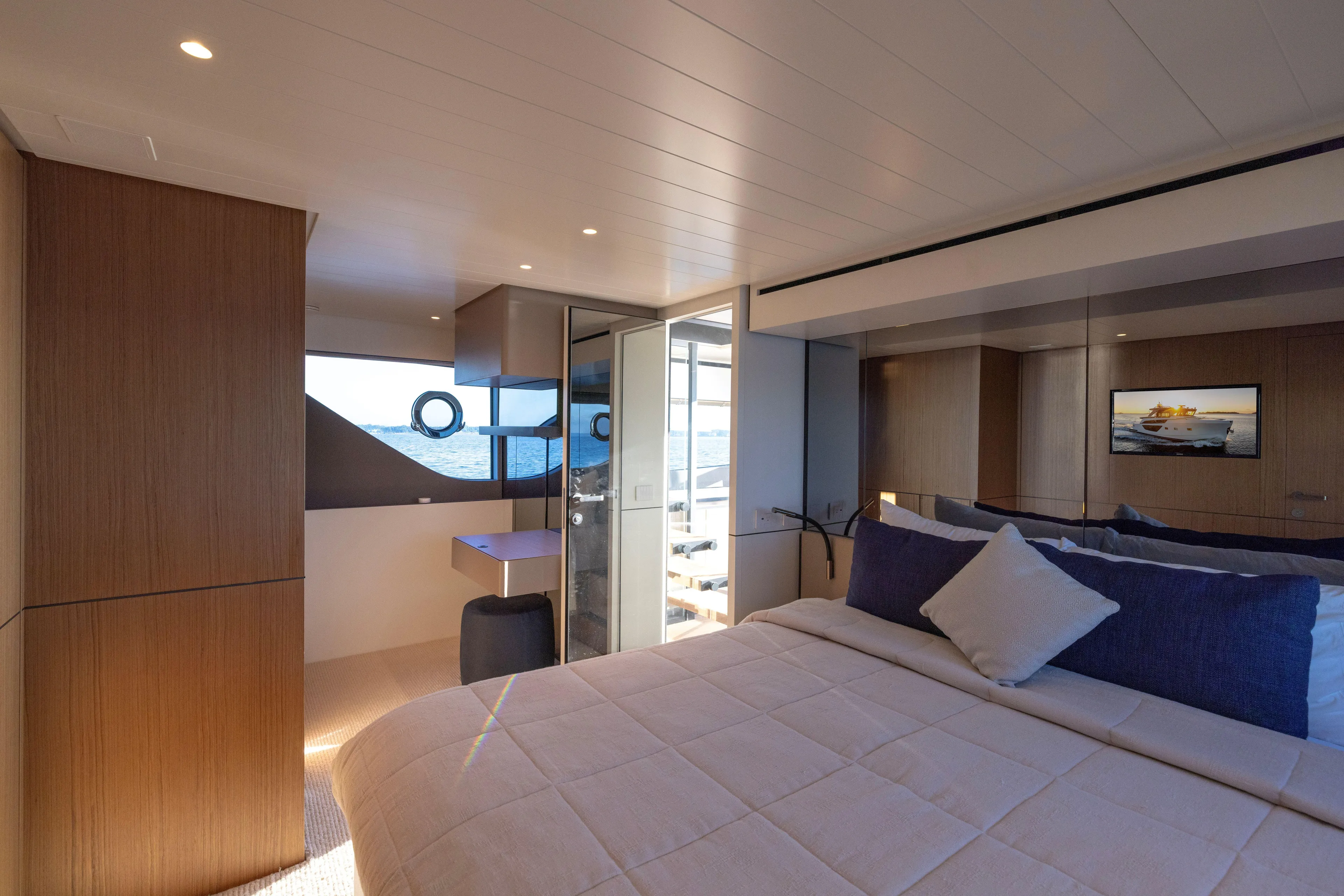 The Calm Down Yacht Photos Pics Luxurious interior of 2024 Bluegame BGX63 yacht with elegant bedroom and ocean view.