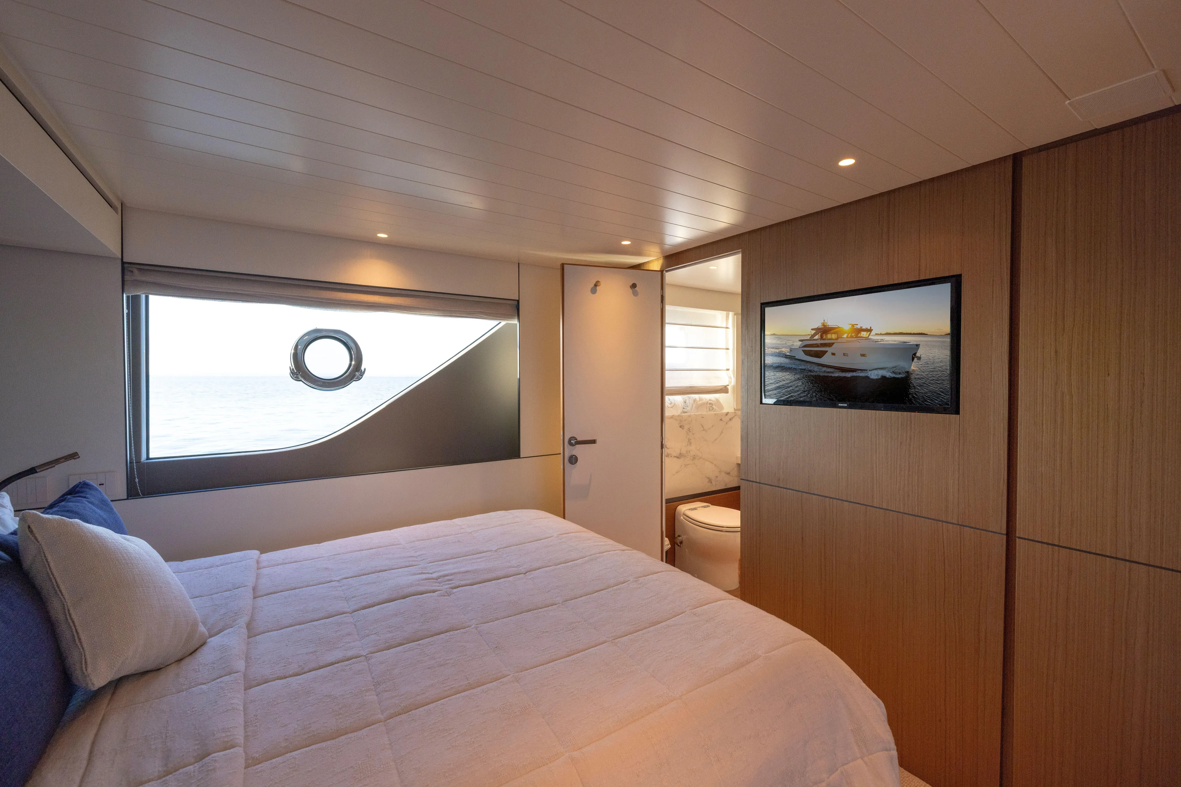 The Calm Down Yacht Photos Pics Luxurious interior of 2024 Bluegame BGX63 yacht bedroom with ocean view and modern amenities.