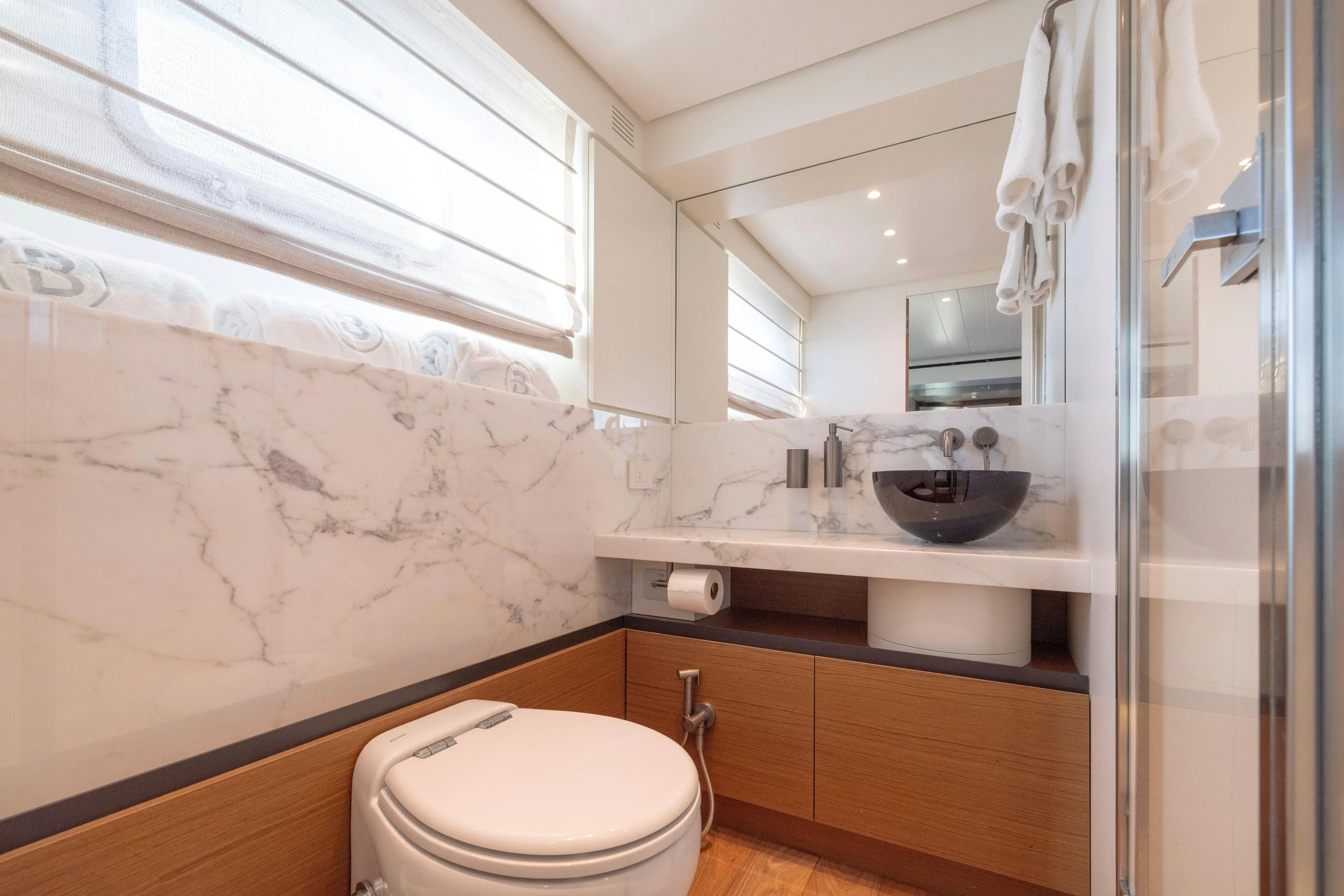 The Calm Down Yacht Photos Pics Luxurious bathroom in 2024 Bluegame BGX63 yacht with marble accents and modern fixtures.