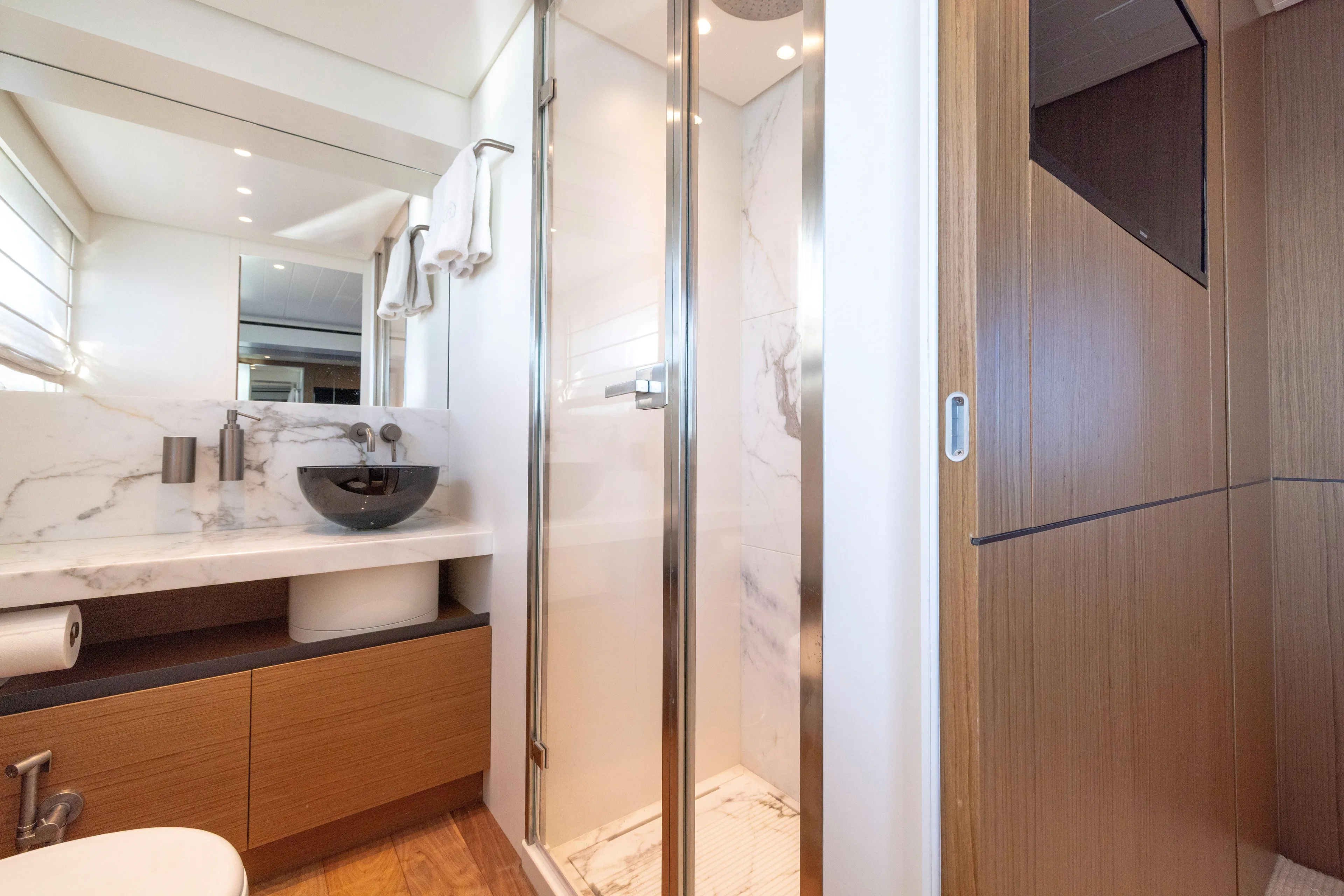 The Calm Down Yacht Photos Pics Luxurious bathroom in 2024 Bluegame BGX63 yacht with modern fixtures and marble accents.