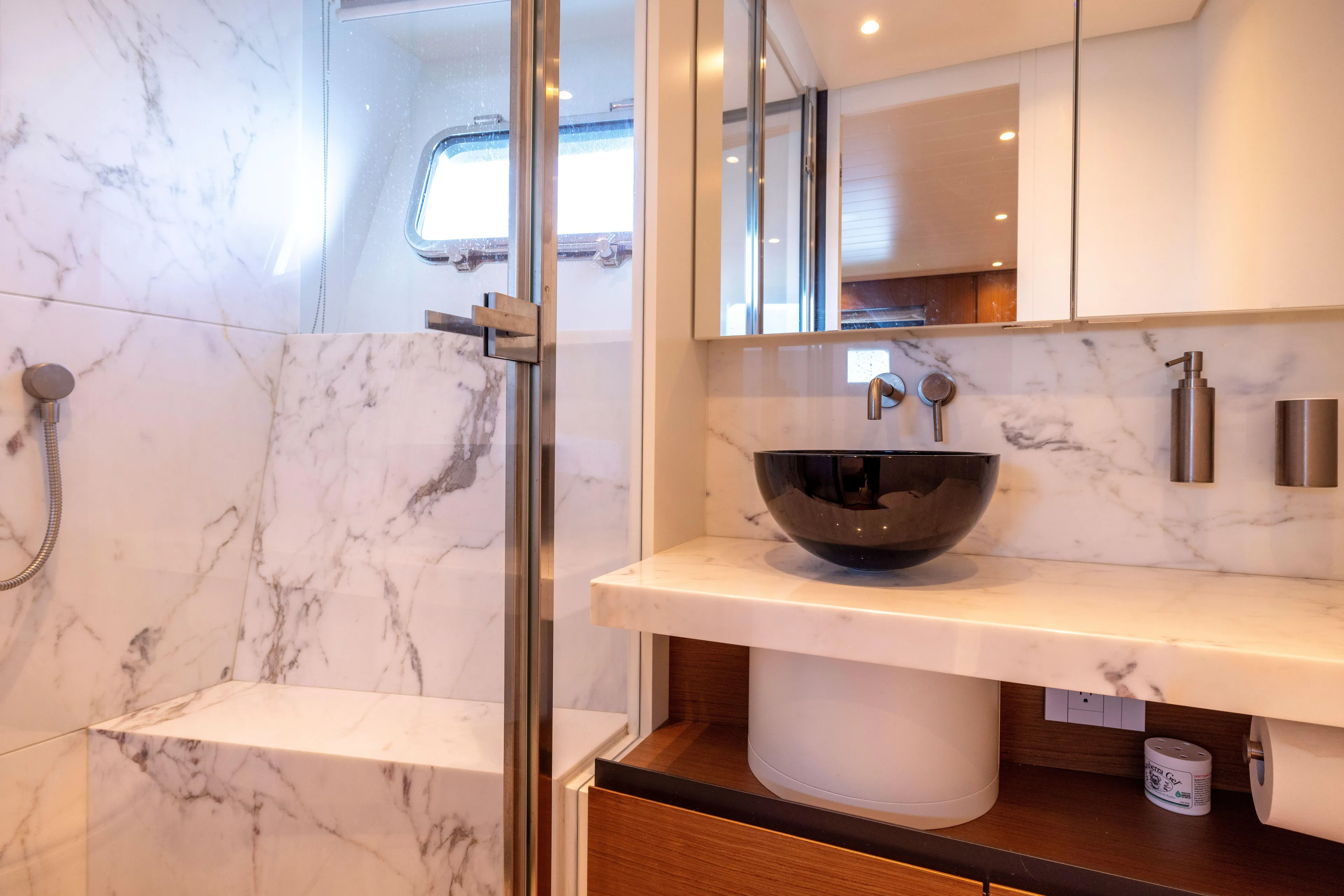 The Calm Down Yacht Photos Pics Luxurious marble bathroom in 2024 Bluegame BGX63 yacht with modern fixtures and elegant design.