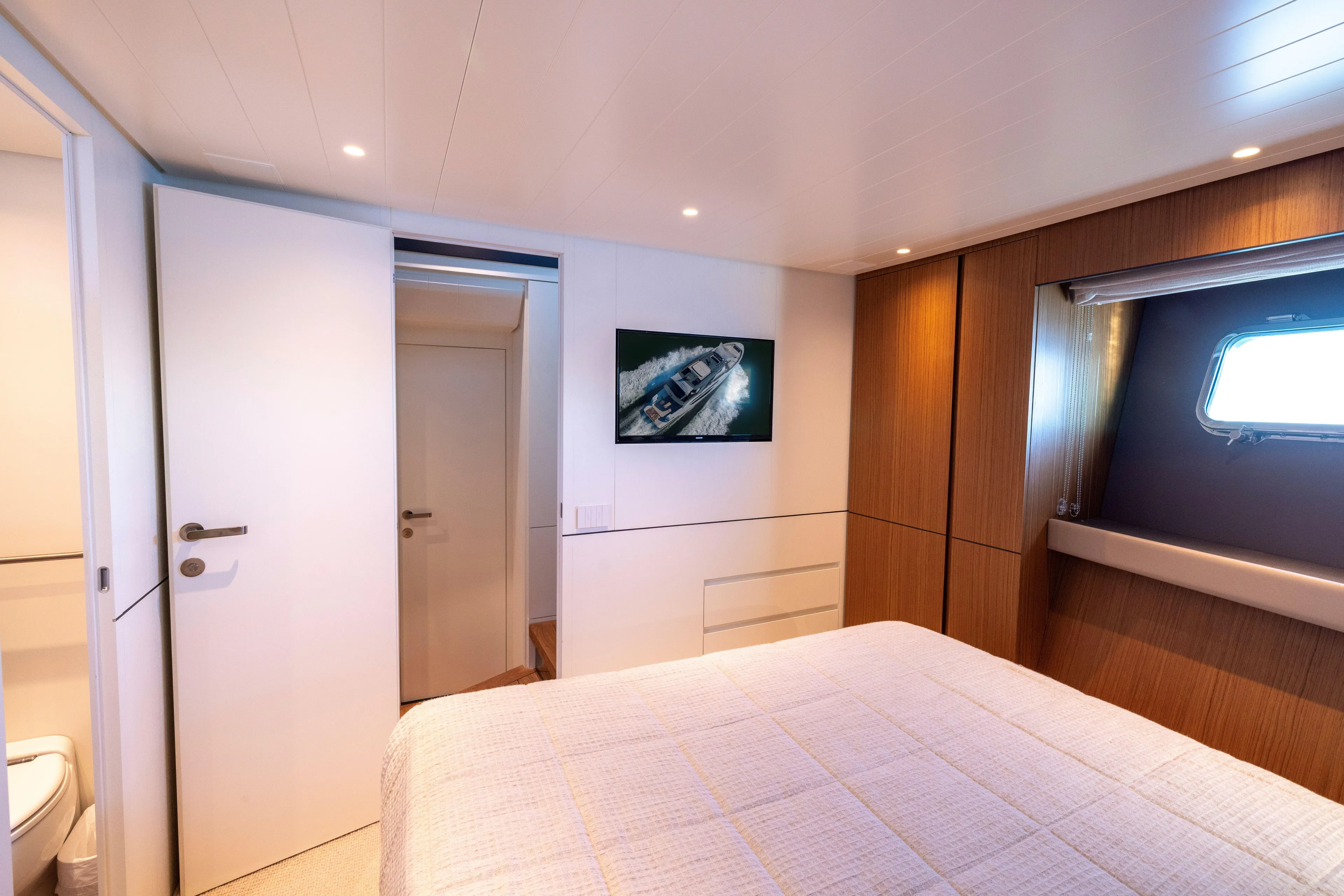 The Calm Down Yacht Photos Pics Luxurious cabin interior of 2024 Bluegame BGX63 yacht with modern design and window view.