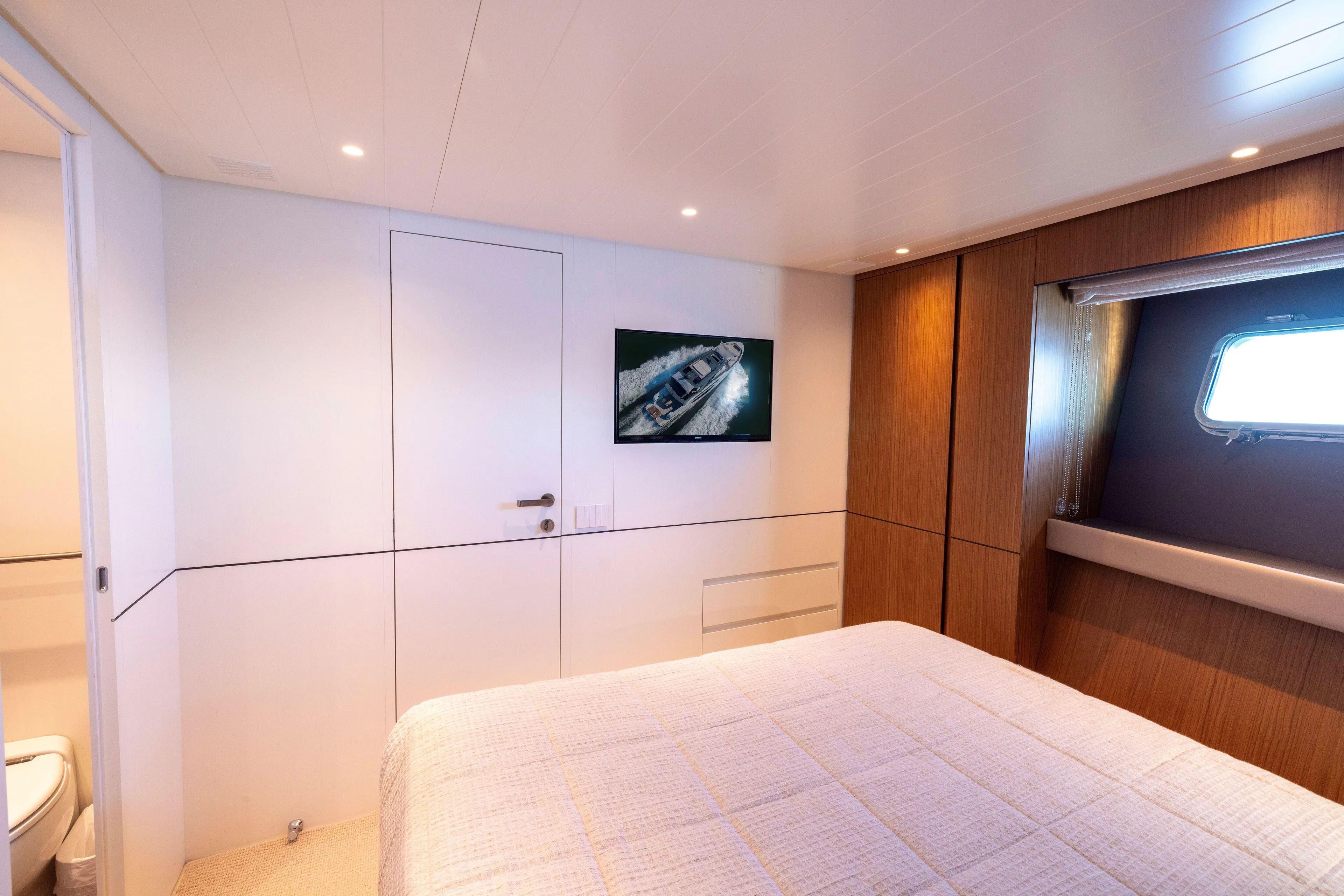 The Calm Down Yacht Photos Pics Luxurious cabin interior of 2024 Bluegame BGX63 yacht with modern design and window view.