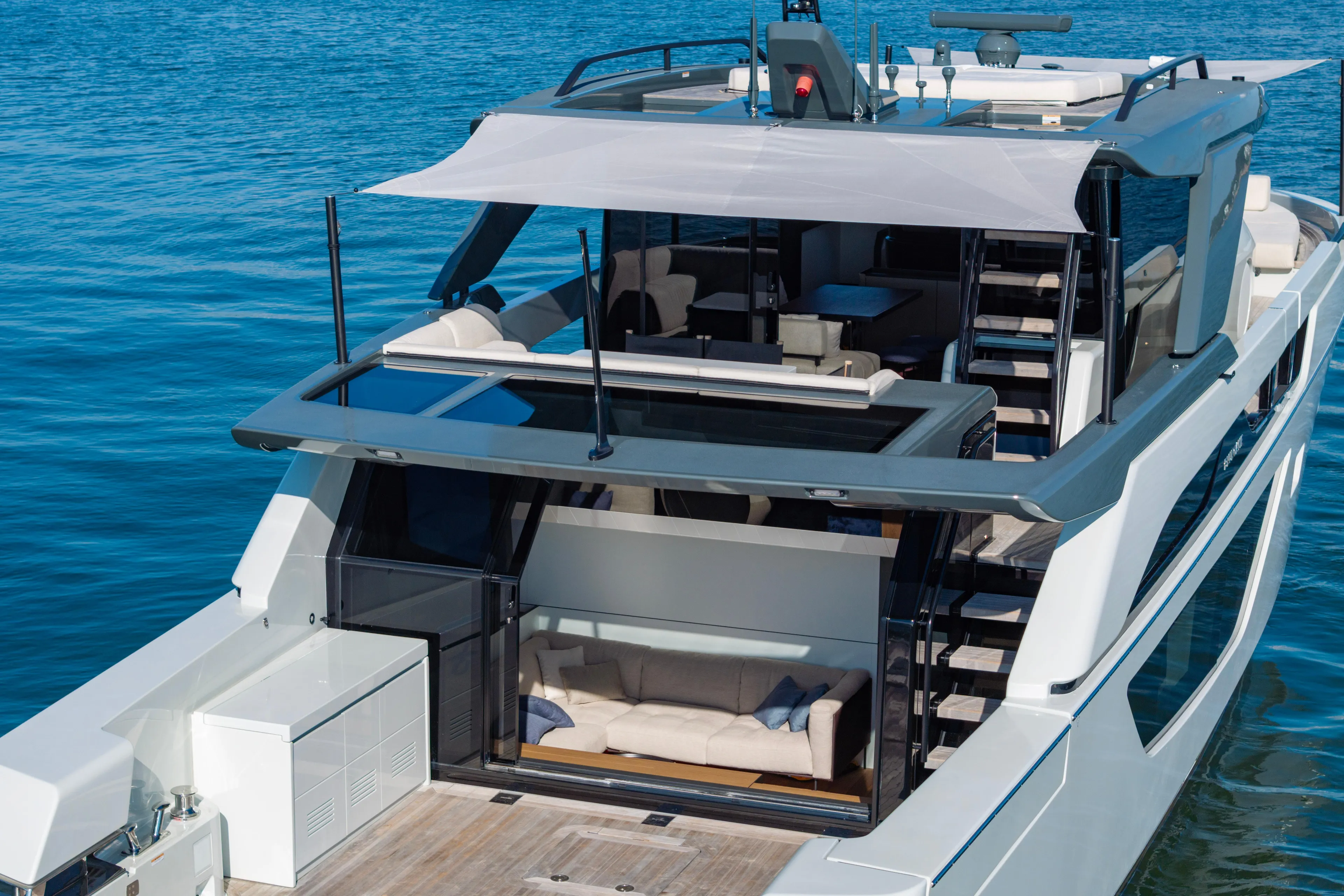The Calm Down Yacht Photos Pics 2024 Bluegame BGX63 yacht with modern design, spacious deck, and luxurious seating on the water.