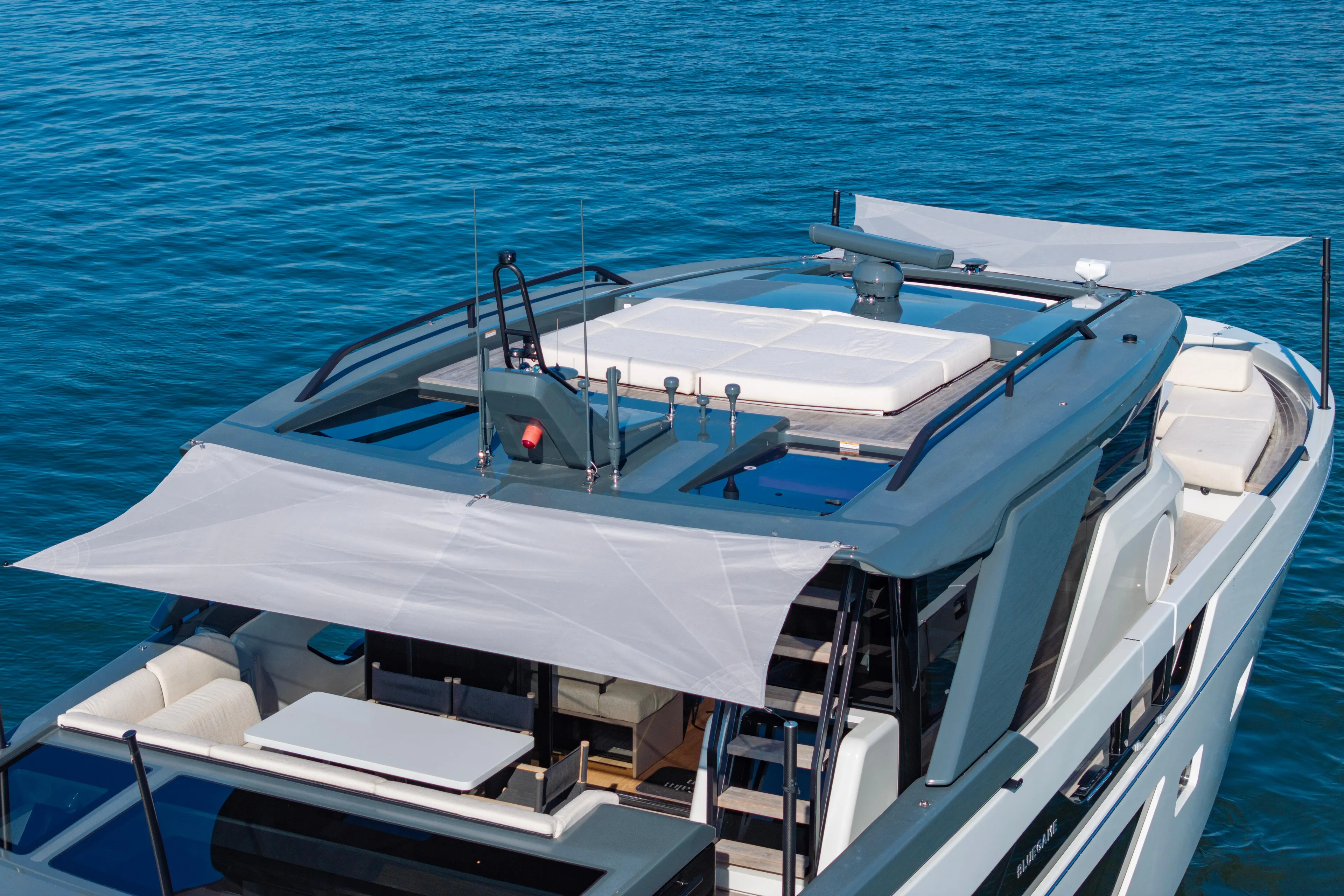 The Calm Down Yacht Photos Pics 2024 Bluegame BGX63 yacht with sleek design and spacious deck on calm blue waters.
