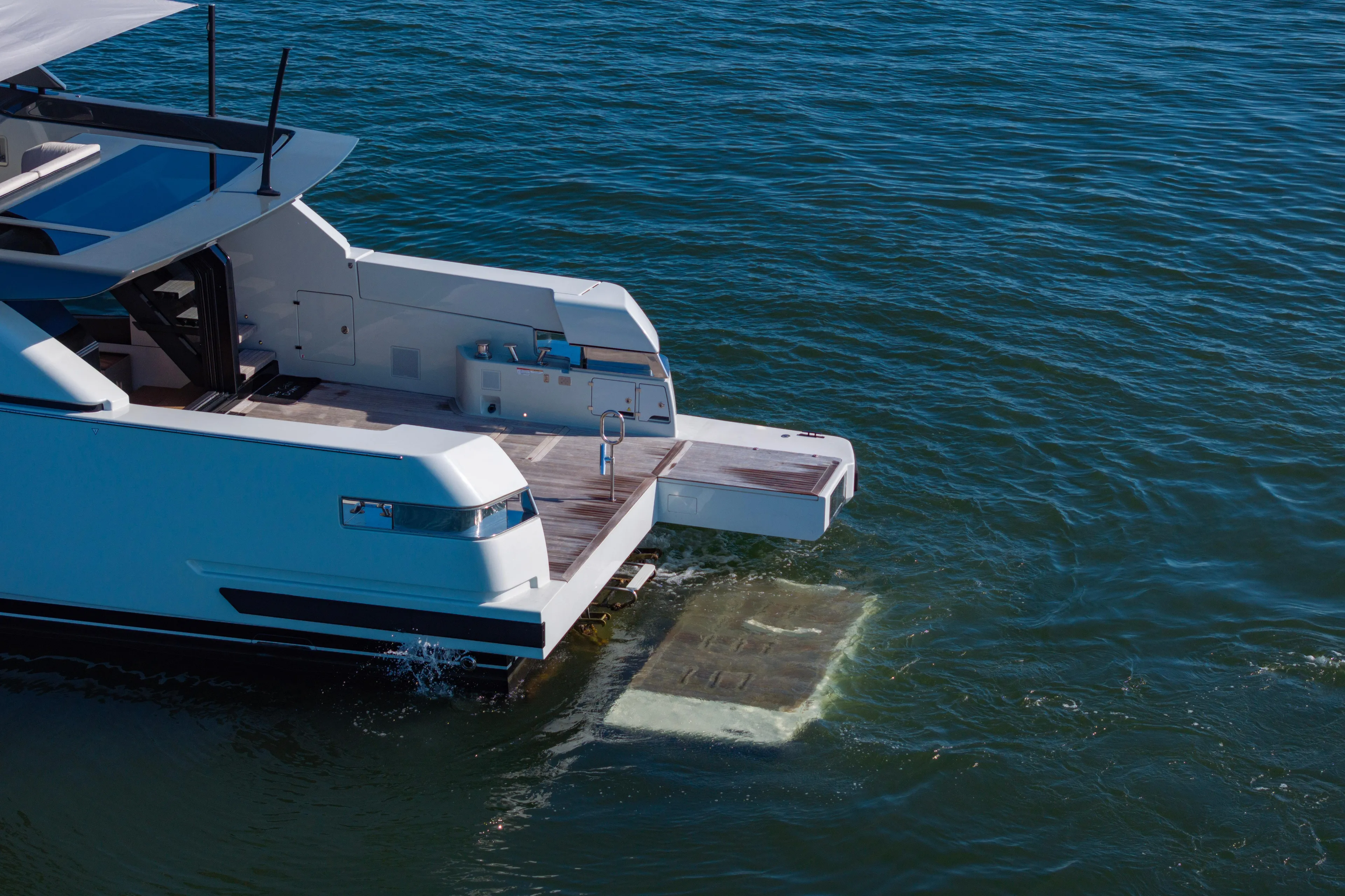 The Calm Down Yacht Photos Pics 2024 Bluegame BGX63 yacht with extended swim platform on calm water.