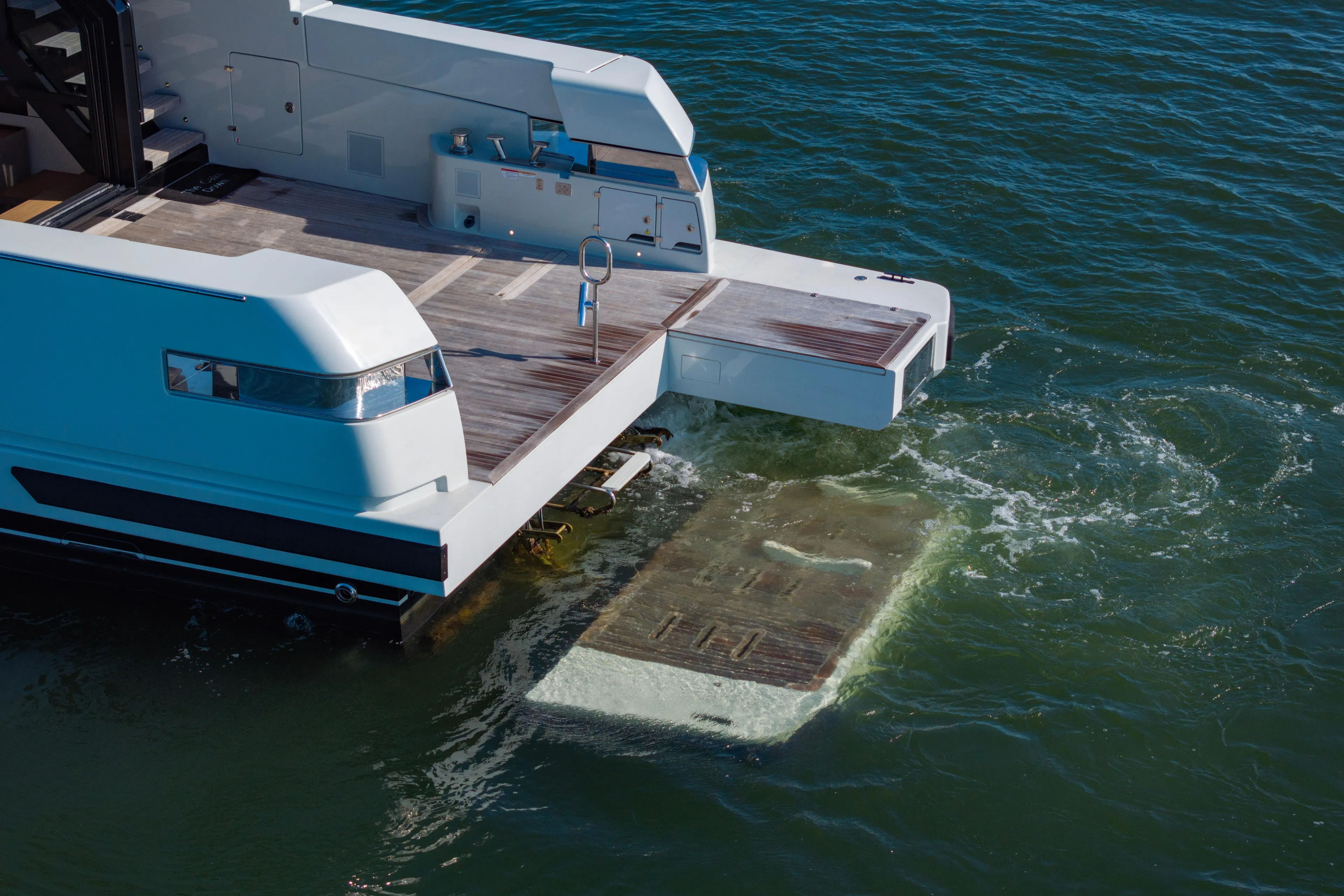 The Calm Down Yacht Photos Pics 2024 Bluegame BGX63 yacht with extended swim platform in water.