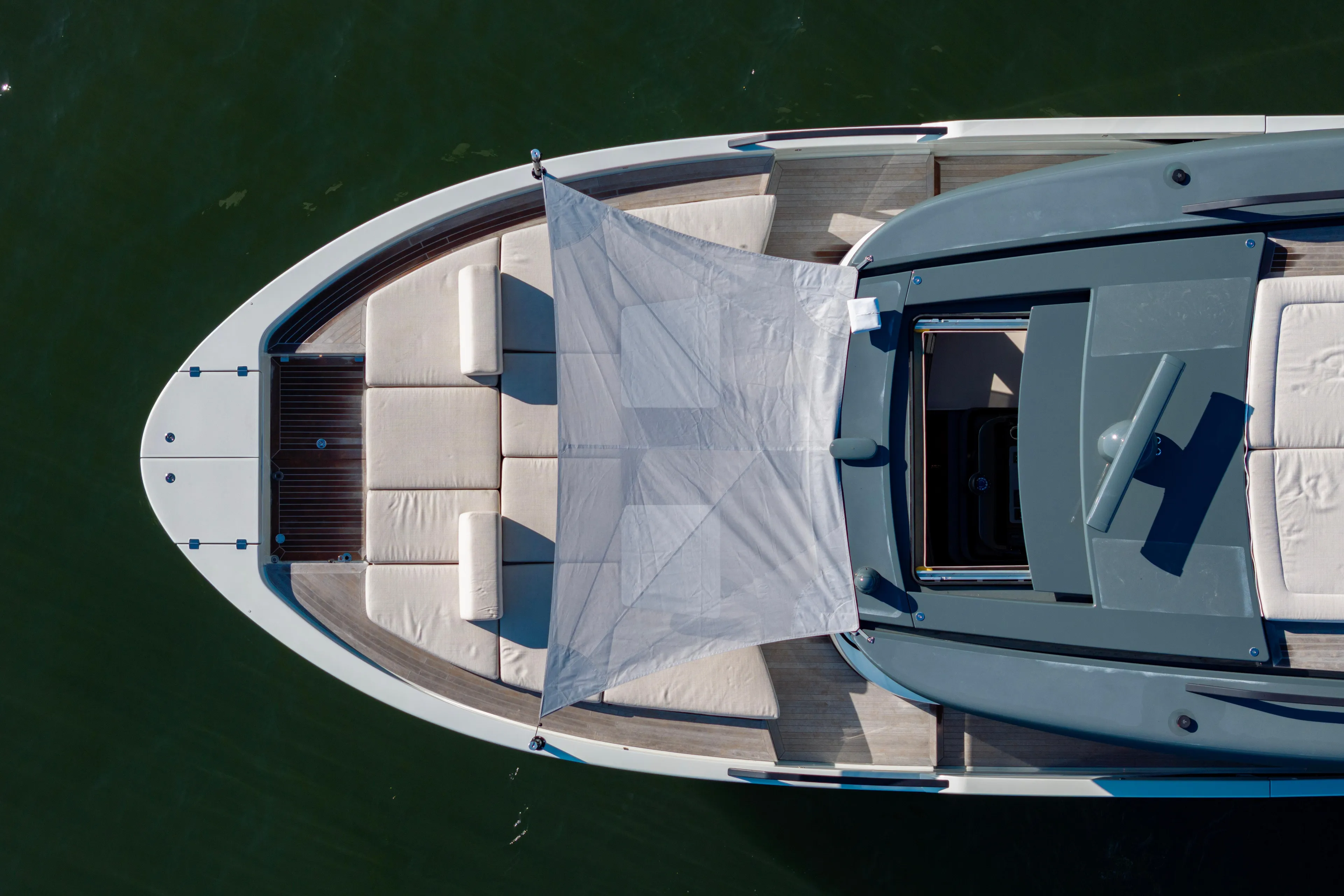 The Calm Down Yacht Photos Pics Top view of 2024 Bluegame BGX63 yacht with sunshade and seating area.