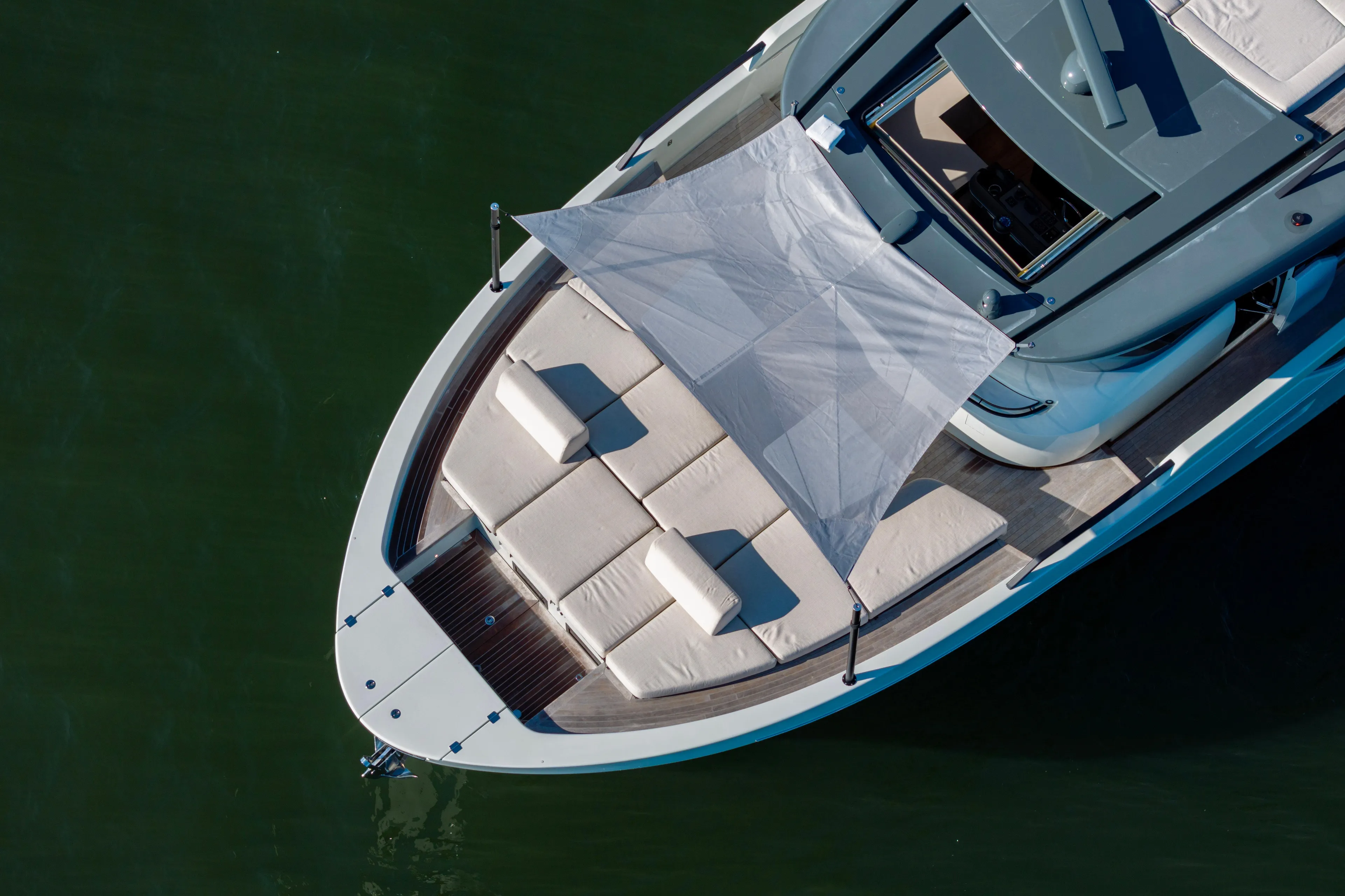 The Calm Down Yacht Photos Pics 2024 Bluegame BGX63 yacht with sunshade and cushioned deck, aerial view.