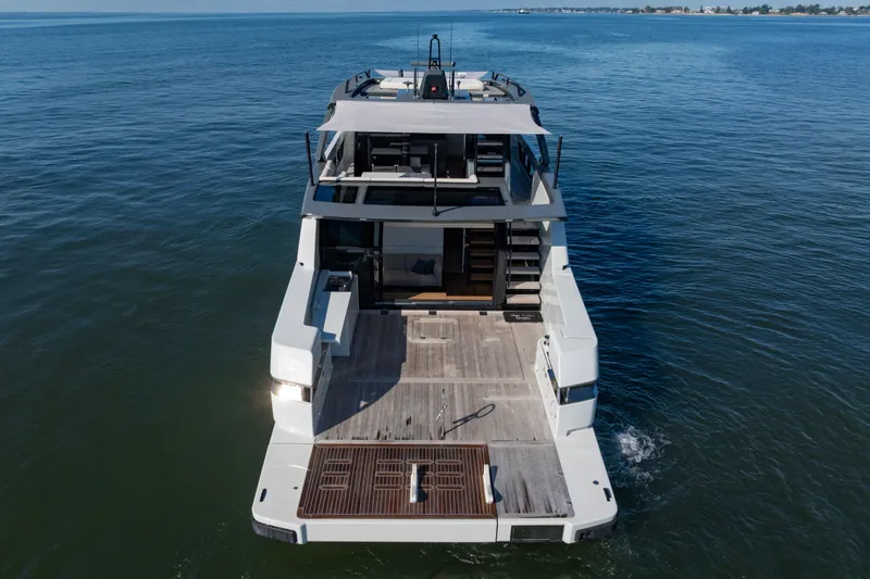 The Calm Down Yacht Photos Pics 2024 Bluegame BGX63 yacht on open water, showcasing spacious deck and modern design.