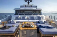 Luxurious 2024 Custom Line Navetta 30 yacht deck with sun loungers and ocean view.