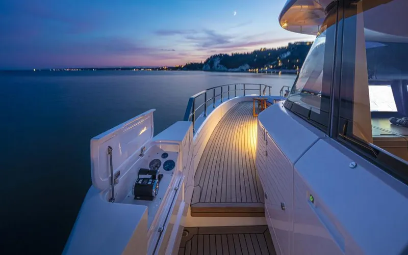 Yacht Photos Pics Luxurious 2024 Custom Line Navetta 30 yacht at sunset, featuring elegant deck and serene ocean view.