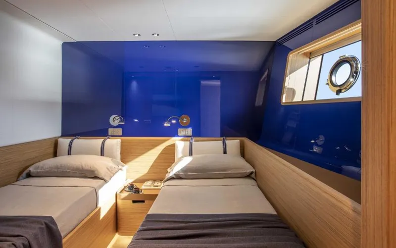  Yacht Photos Pics Luxurious twin cabin on 2024 Custom Line Navetta 30 yacht, featuring modern design and blue accents.