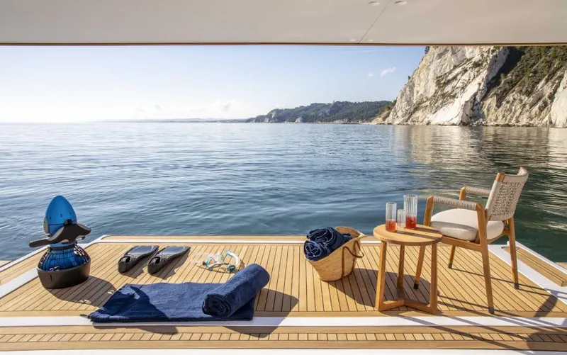  Yacht Photos Pics Luxurious 2024 Custom Line Navetta 30 yacht deck with ocean view, towels, and refreshments.