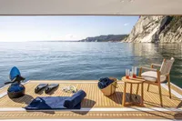 Luxurious 2024 Custom Line Navetta 30 yacht deck with ocean view, towels, and refreshments.