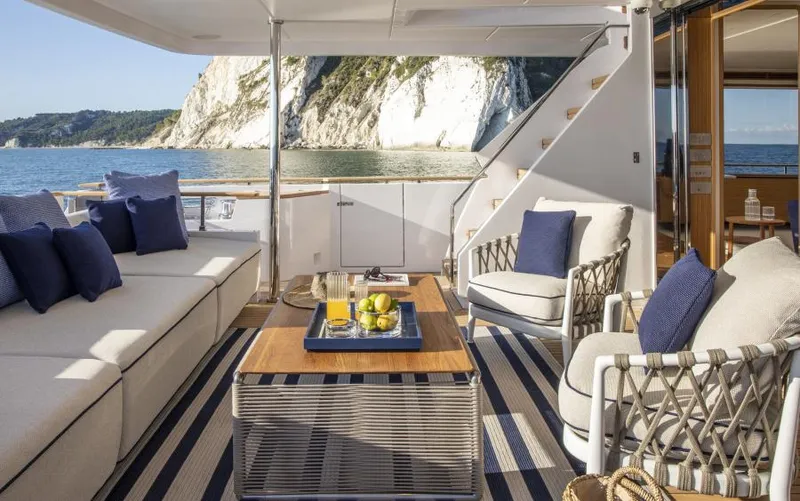 Yacht Photos Pics Luxurious 2024 Custom Line Navetta 30 yacht deck with elegant seating and ocean view.