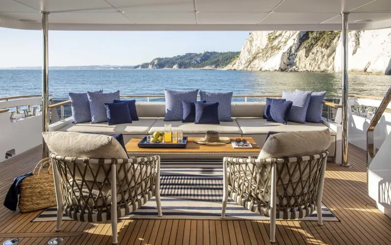  Yacht Photos Pics Luxurious 2024 Custom Line Navetta 30 yacht deck with elegant seating and ocean view.
