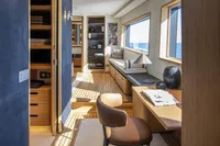 Luxurious interior of 2024 Custom Line Navetta 30 yacht with elegant wood finishes and ocean view.