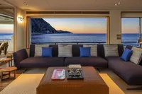 Luxurious 2024 Custom Line Navetta 30 yacht interior with ocean view at sunset.