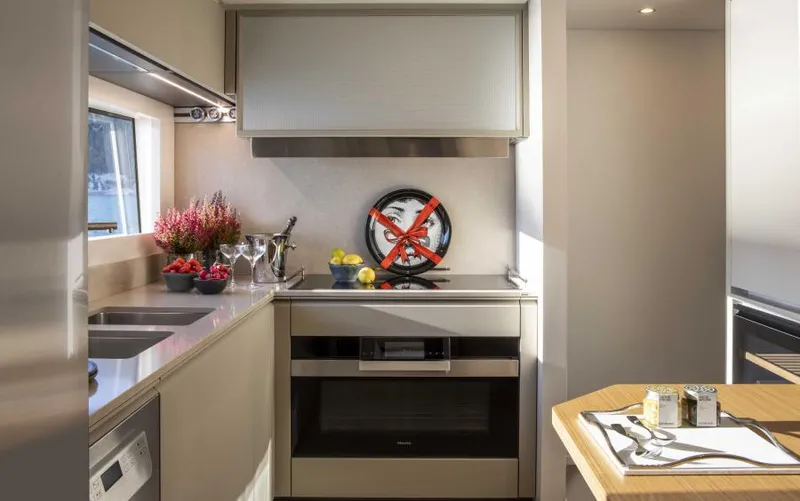  Yacht Photos Pics Modern kitchen interior on 2024 Custom Line Navetta 30 yacht, featuring sleek appliances and decor.