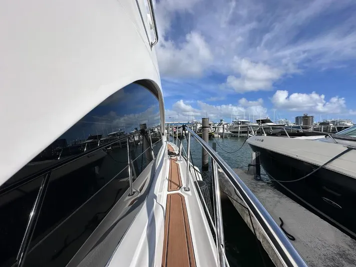 Selene Yacht Photos Pics 2007 Sea Ray 360 Sedan Bridge yacht docked at marina under blue sky.