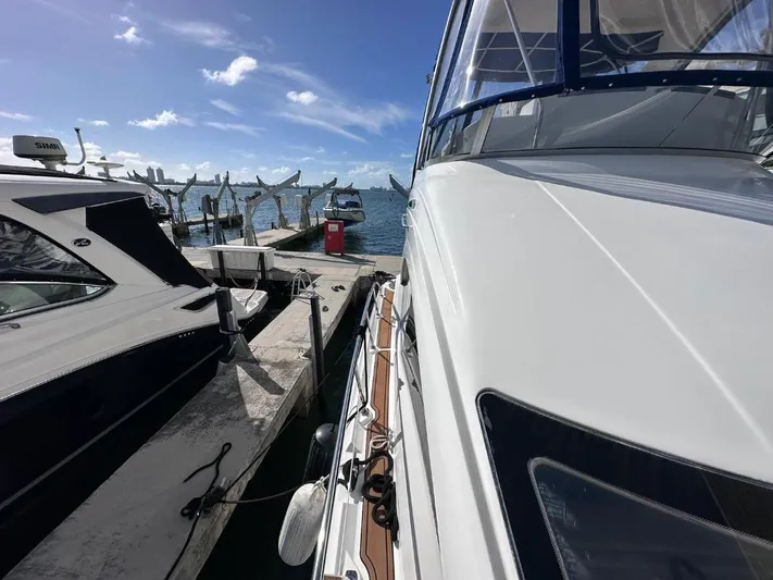 Selene Yacht Photos Pics 2007 Sea Ray 360 Sedan Bridge yacht docked at marina under clear blue sky.