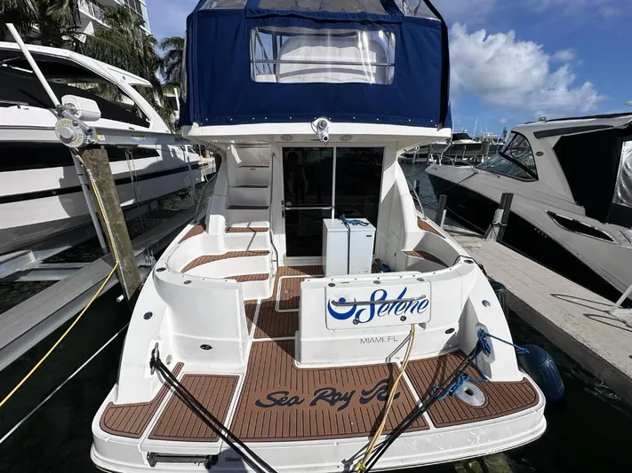 Selene Yacht Photos Pics 2007 Sea Ray 360 Sedan Bridge docked, featuring spacious deck and blue canopy.