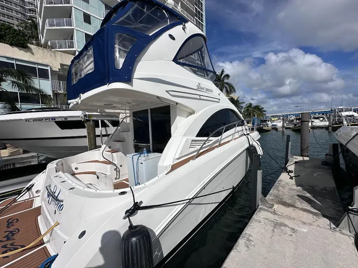Selene Yacht Photos Pics 2007 Sea Ray 360 Sedan Bridge yacht docked at marina under blue sky.