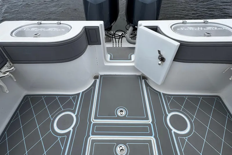  Yacht Photos Pics 2013 SeaHunter 33 Tournament boat deck with storage compartments and dual engines.