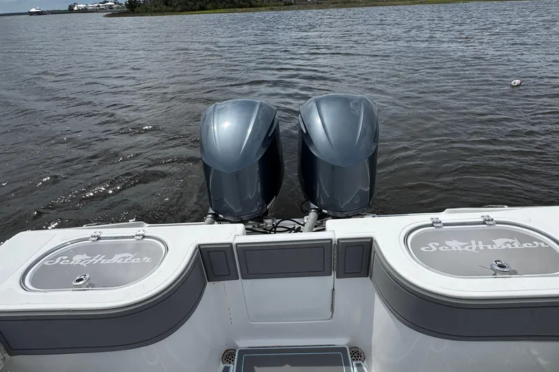  Yacht Photos Pics 2013 SeaHunter 33 Tournament boat with dual outboard motors on a calm waterway.