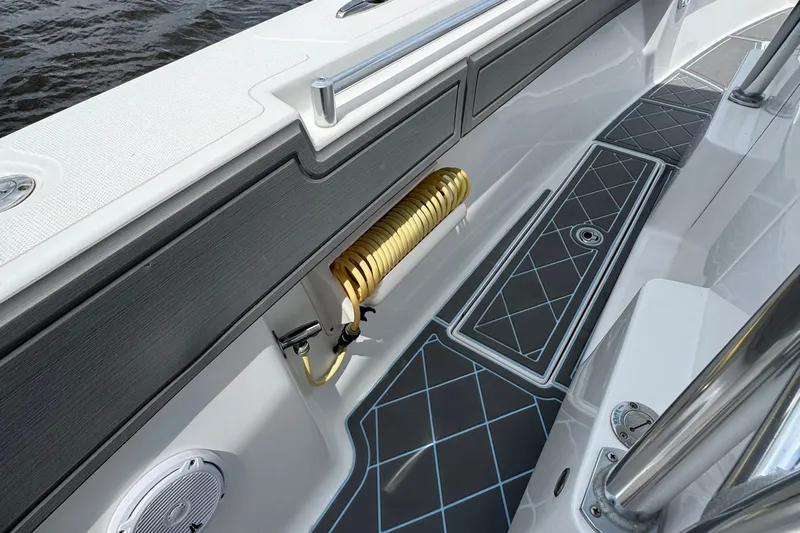  Yacht Photos Pics 2013 SeaHunter 33 Tournament boat interior with coiled hose and patterned flooring.