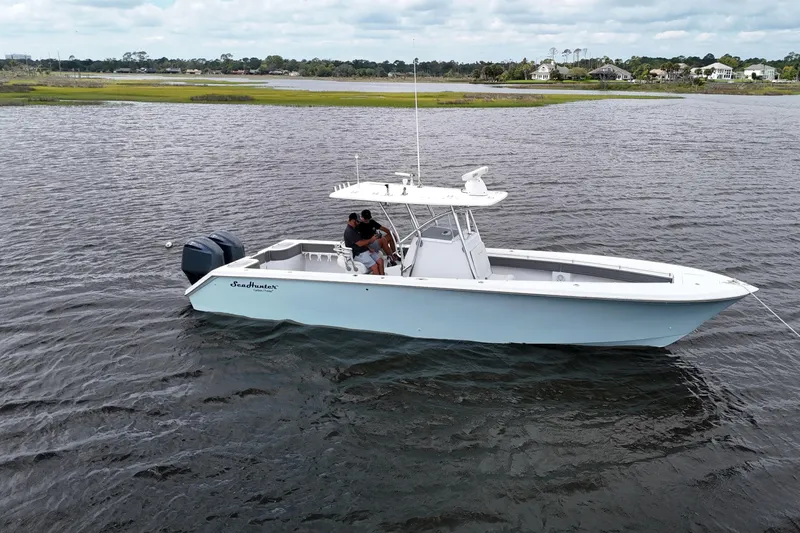  Yacht Photos Pics 2013 SeaHunter 33 Tournament boat on water, featuring dual engines and sleek design.
