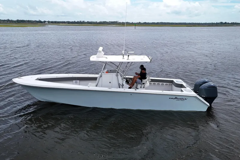  Yacht Photos Pics 2013 SeaHunter 33 Tournament boat on water, featuring dual engines and center console.