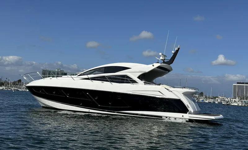 Tucker II Yacht Photos Pics 2015 Sunseeker Predator 57 yacht on calm water under blue sky.