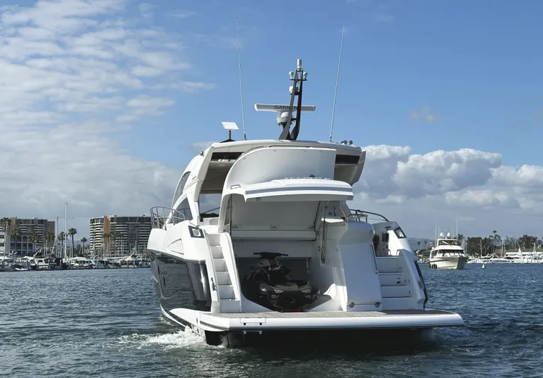 Tucker II Yacht Photos Pics 2015 Sunseeker Predator 57 yacht on water, rear view with open garage, clear sky.