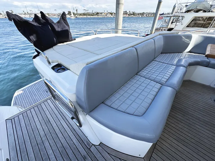 Tucker II Yacht Photos Pics Luxurious seating area on a 2015 Sunseeker Predator 57 yacht, overlooking serene waters.