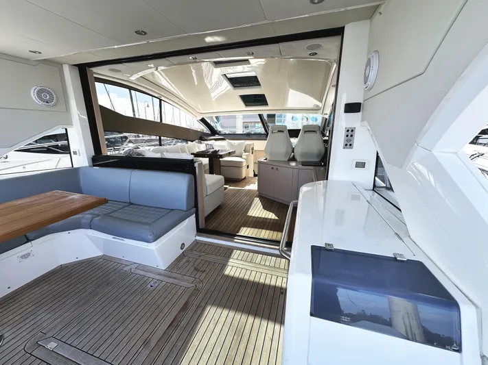 Tucker II Yacht Photos Pics 2015 Sunseeker Predator 57 yacht interior with seating and helm, showcasing luxury design.