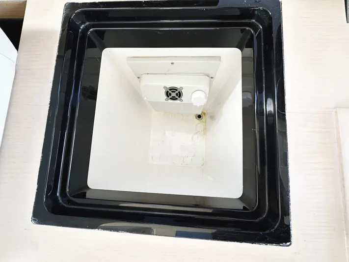 Tucker II Yacht Photos Pics Sunseeker Predator 57 2015 yacht interior detail, featuring a built-in compartment with a fan.