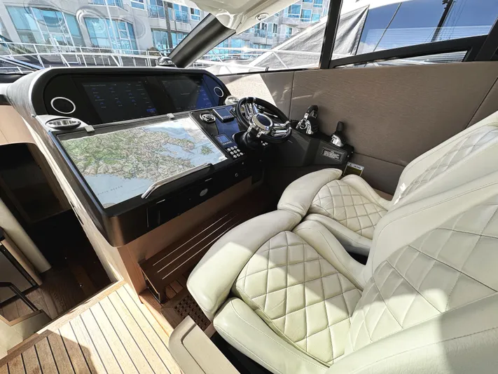 Tucker II Yacht Photos Pics Luxurious 2015 Sunseeker Predator 57 yacht cockpit with plush seating and advanced navigation controls.