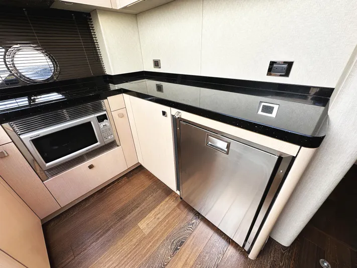 Tucker II Yacht Photos Pics Modern kitchen area in 2015 Sunseeker Predator 57 yacht with microwave and fridge.