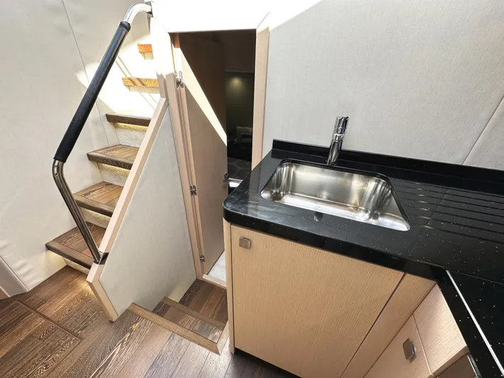 Tucker II Yacht Photos Pics Interior of 2015 Sunseeker Predator 57 yacht with stairs and kitchenette.