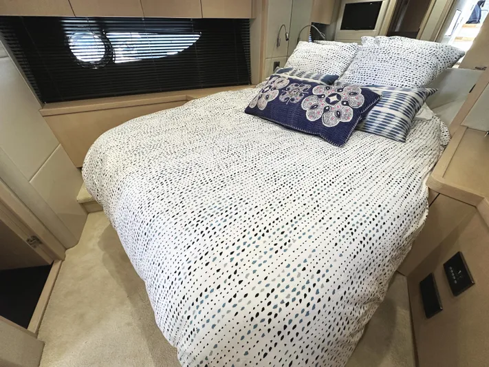 Tucker II Yacht Photos Pics Luxurious bedroom interior of 2015 Sunseeker Predator 57 yacht with patterned bedding.